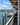 weather-resistant pvc bracket for use on mailbox or porch post decor, in shape of pelican, hand-painted in vibrant colors mounted on post of restaurant by the water