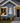 white pvc Christmas tree wall art on front of holiday decorated house