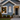 white pvc Christmas tree wall art on front of holiday decorated house
