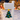 hand-painted Christmas tree bracket on mailbox post in front of holiday decorations 