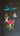 Colorful handpainted hummingbird and flower mobile against a dark background