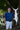 Man holding a large white swordfish wall art outdoors with trees in the background