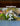 Decorative hanging mobile made from white pvc with birds and flowers against a blurred natural background