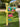 Decorative mailbox with painted flamingo bracket design on a grassy lawn