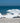 White mermaid holding wine glass wall art on a sandy beach with ocean in the background