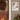 house plaque featuring a cardinal with house number below framed shown on a house decorated for holidays
