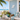 white conch shell pvc wall art on light blue house by the beach
