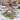 deer decorative bracket on a mailbox in front of holiday decorated home in snowy scene