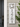 white pvc house plaque featuring a hummingbird in square cutout above the house numbers displayed vertically shown here on the front of a grey house
