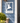 house plaque featuring hummingbird with house numbers below made of white weather-resistant pvc shown on a blue house
