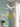 A colorful hummingbird and flower hanging mobile made from painted pvc suspended from a white cross-shaped  hanging from ceiling in a soft color room