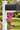 decorative mailbox bracket in shape of charity ribbon in pink on a mailbox post in grassy area
