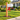 decorative mailbox bracket in shape of charity ribbon in red on a mailbox post in grassy yard
