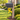 decorative mailbox bracket in shape of charity ribbon in yellow on a mailbox post in grassy area