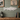 Decorative salmon wall art on a wooden shelf with a rustic setting.