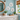 3 decorative white sand dollars made from pvc as decor on coastal themed bathroom