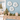 three sand dollar wall art pieces on blue wall with holiday decor in the room
