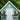 white weather-resistant pvc wall art in shape of seahorse mounted on outdoor garden she-shed, with window boxes of colorful flowers