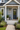 light grey house with white pvc house plaque with 4 baby turtles and word "welcome" at the bottom 